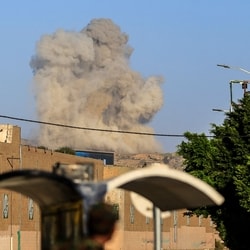 A plume of smoke rises during a reported airstrike by the Saudi-led coalition on the Houthi-controlled Yemeni capital Sanaa, on October 9, 2026. 