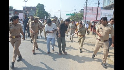 Mission Shakti police team personnel taking the two nabbed accused to police station on foot in Pratapgarh on Tuesday (HT)