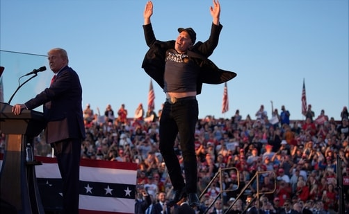 FILE - Elon Musk jumps on the stage as Republican presidential nominee former President Donald Trump speaks at a campaign rally at the Butler Farm Show in Butler, Pa., on Oct. 5, 2024