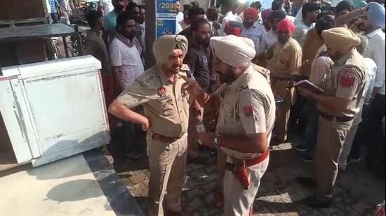 Police outside the chemist shop in Mansa, where anti-drug activist Parminder Singh Jhota was shot at on Tuesday morning. He later succumbed to injuries in hospital. (HT Photo)