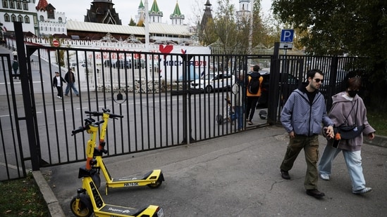 People walk past Yandex electric scooters in Moscow, Russia, October 11, 2026. REUTERS/Anastasia Barashkova