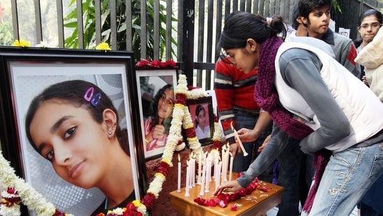 In this file photo friends and relatives of Aarushi Talwar light candles near her portrait to seek justice for her at Jantar Mantar in New Delhi in Jan 2011. (HT File Photo)