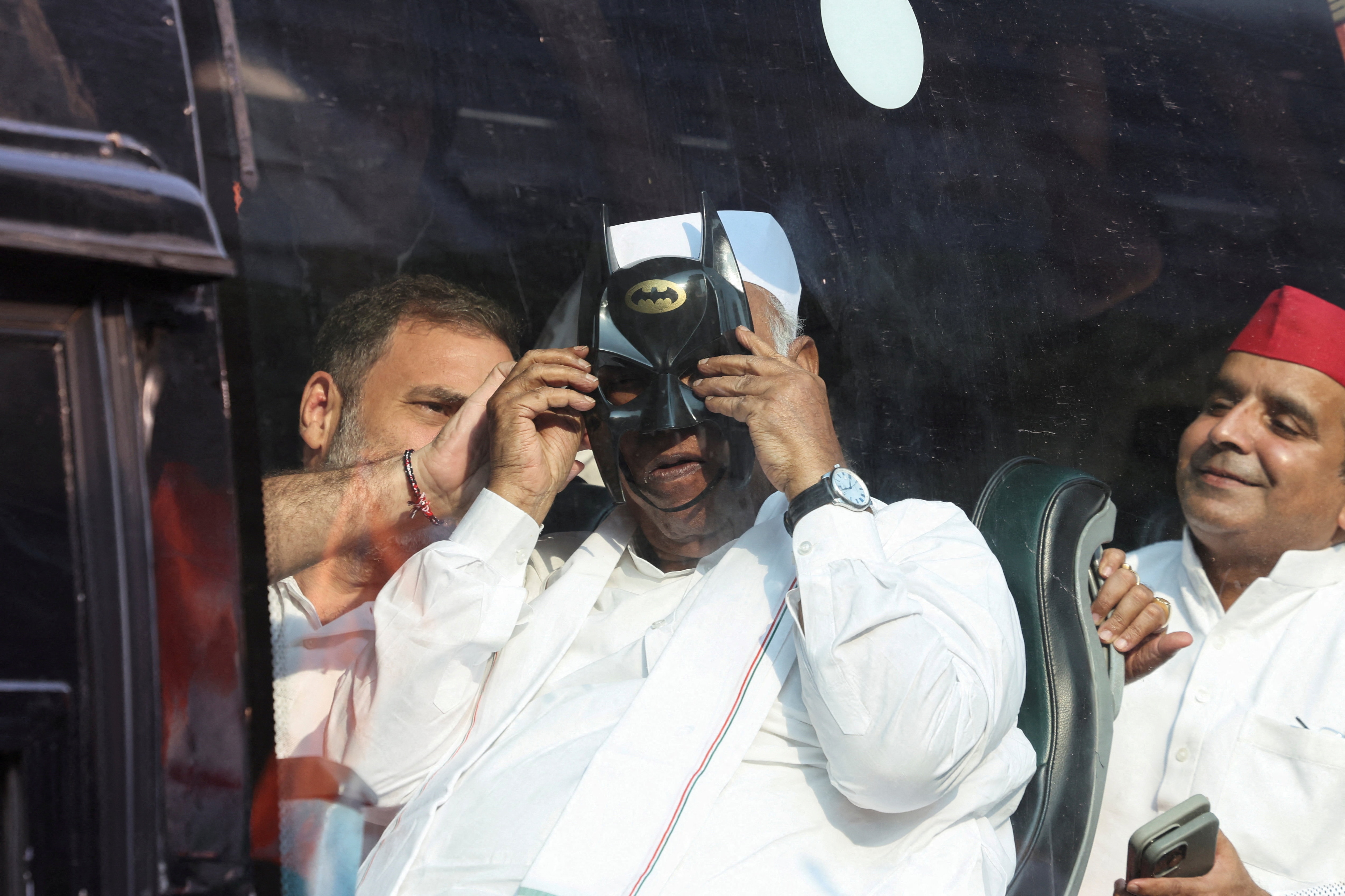 Congress leader and Leader of Opposition Rahul Gandhi helps President of the Indian National Congress Mallikarjun Kharge put on a Batman mask, as opposition parties march to the Supreme Court to protest a controversial revision of voter lists that has sparked days of unrest, in New Delhi, India, October 12, 2026. (REUTERS) Congress leader and Leader of Opposition Rahul Gandhi helps President of the Indian National Congress Mallikarjun Kharge put on a Batman mask, as opposition parties march to the Supreme Court to protest a controversial revision of voter lists that has sparked days of unrest, in New Delhi, India, October 12, 2026. (REUTERS)