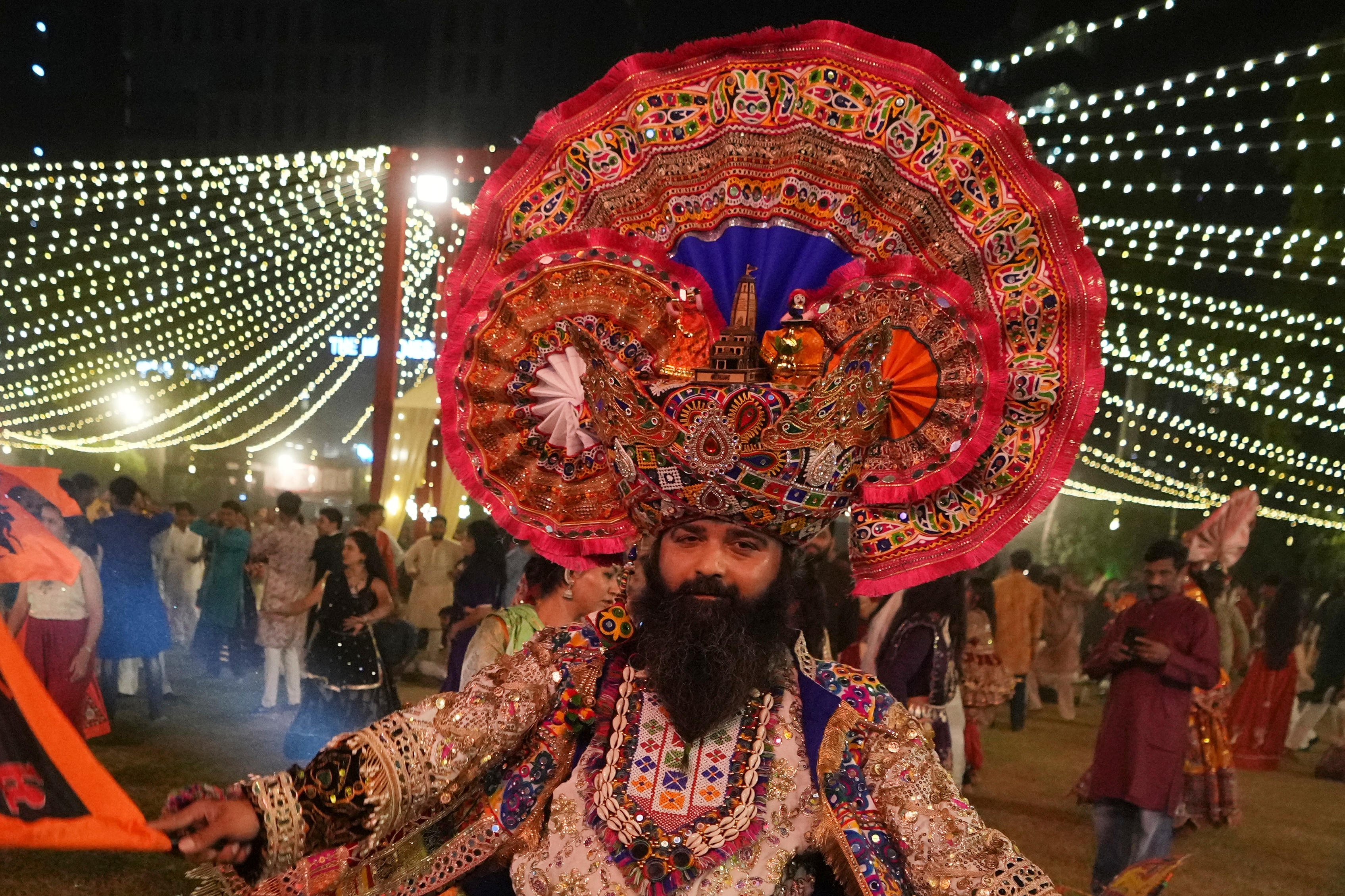 A man in traditional attire performs Gujarat state's folk dance called Garba during the celebration of nine nights Hindu festival Navratri, in Ahmedabad. (AP Photo)