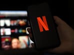 In this file photo illustration a computer and a mobile phone screens display the Netflix logo on March 31, 2020 in Arlington, Virginia.