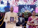 Chief minister Yogi Adityanath, along with former President Ram Nath Kovind and his wife, launch the Hindi edition of the former President’s autobiography at Lok Bhavan, in Lucknow on Wednesday. (PTI PHOTO)