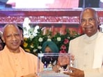 Chief minister Yogi Adityanath presents a memento to former President Ram Nath Kovind during the launch of the Hindi edition of his autobiography at Lok Bhavan, in Lucknow on Wednesday. (ANI PHOTO)