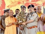 DGP Rajeev Krishna felicitates chief minister Yogi Adityanath during an event organised to honour 68,000 Gram Praharis of the state, in Bareilly on Tuesday. (@myogiadityanath X/ANI Photo)