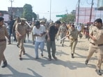 Mission Shakti police team personnel taking the two nabbed accused to police station on foot in Pratapgarh on Tuesday (HT)
