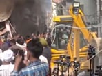 Smoke billowing from accused Ashwani Kumar's shop (L) and his house being demolished by the administration (R)