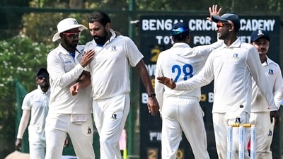 Mohammed Shami celebrates with teammates after taking the wicket of Delhi's Divij Mehra. (PTI) Mohammed Shami celebrates with teammates after taking the wicket of Delhi's Divij Mehra. (PTI)
