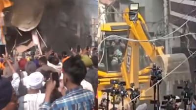 Smoke billowing from accused Ashwani Kumar's shop (L) and his house being demolished by the administration (R) (Screengrab from X/@ANI) Smoke billowing from accused Ashwani Kumar's shop (L) and his house being demolished by the administration (R) (Screengrab from X/@ANI)