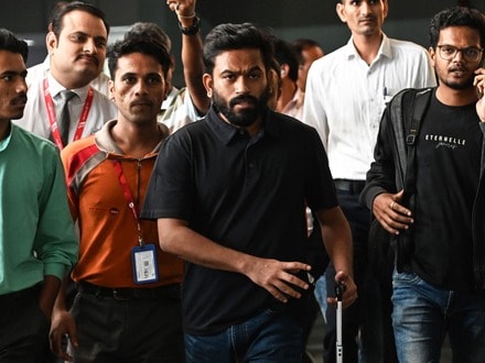 Cockroach Janta Party (CJP) founder Abhijeet Dipke (C) arrives at the Indira Gandhi International Airport in New Delhi on October 14, 2026 amid ongoing protests against India's Chief Election Commissioner Gyanesh Kumar over alleged voter roll irregularities linked to the "special intensive revision" (SIR). (Photo by AFP) / ALTERNATIVE CROP