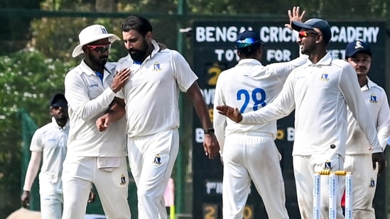 Mohammed Shami celebrates with teammates after taking the wicket of Delhi's Divij Mehra.