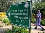 A security personnel walks along a road near Jantar Mantar in New Delhi.