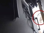 A man described as Abdulrahman Alfozan, a Saudi national employed as an OpenAI engineer, looks behind a television where a recording device had been placed at a conference room in OpenAI offices, in a still image from surveillance video included in a charging document after US federal agents the man and charged him with installing a hidden audio recording device, in San Francisco, California, US, October 5, 2026.  