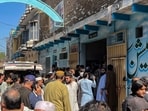 Residents gather during a search operation after a roof collapsed at a school in Peshawar on October 15, 2026. Sixteen pupils and a teacher were killed on October 15 after a roof collapsed at a school in the northwest Pakistani city of Peshawar, emergency services said. 