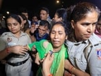 Police personnel detain parents of 19-year-old Ankita Bhandari, who was murdered in Uttarakhand in 2022, while protesting near India Gate against Dushyant Kumar Gautam's appointment as Sikkim governor, in New Delhi. 