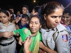 Police personnel detain the mother of 19-year-old Ankita Bhandari, who was murdered in Uttarakhand in 2022, while protesting near India Gate against Dushyant Kumar Gautam's appointment as Sikkim governor, in New Delhi.