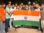 Cockroach Janta Party (CJP) founder Abhijeet Dipke along with party activists pose with the national tricolour following their release after being detained by Delhi Police near Jantar Mantar