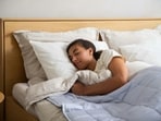 Expert explains whether sleeping on your back or side is better for spinal alignment.