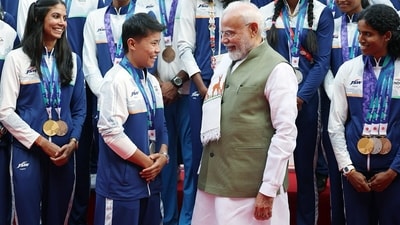 Prime Minister Narendra Modi with wushu silver medallist Roshibina Devi. (@narendramodi X) Prime Minister Narendra Modi with wushu silver medallist Roshibina Devi. (@narendramodi X)