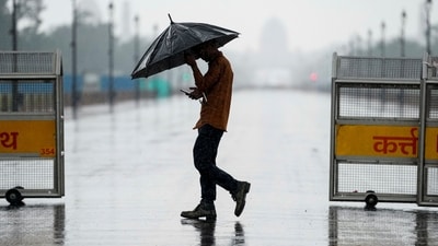 A man makes his way amid rainfall, at India Gate, in New Delhi, Thursday, (PTI) A man makes his way amid rainfall, at India Gate, in New Delhi, Thursday, (PTI)