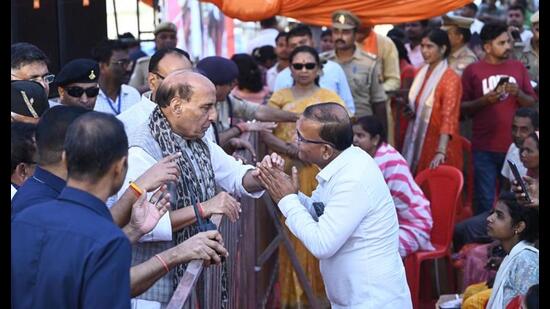 Defence minister Rajnath Singh interacts with people affected by floods in Faizullaganj. on Thursday. (Deepak Gupta/HT Photo)