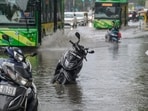 Commuters walk through a waterlogged stretch on Vikas Marg near ITO following heavy rain in New Delhi, India, on Thursday, October 15, 2026.