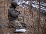 A Ukrainian serviceman prepares a Starlink satellite internet systems at his positions at a front line, amid Russia's attack on Ukraine, near the town of Avdiivka.