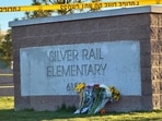 Flowers are placed beside a sign at Silver Rail Elementary School in Bend, Oregon on Friday, Oct. 16.