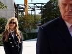 New White House Press Secretary Katie Zacharia stands behind US President Donald Trump as he departs the White House in Washington DC, October 13.