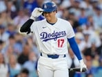 Shohei Ohtani’s knee and biceps injuries spark fan backlash against Dodgers manager Dave Roberts for keeping the struggling star in the lineup. (AP Photo/Ashley Landis)