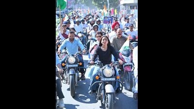 Congress’ Uttarakhand-in-charge Kumari Selja (sitting pillion on a bike at the front) leads a protest march in Dehradun on Friday against Dushyant Kumar Gautam’s appointment as Sikkim governor. (HT PHOTO)