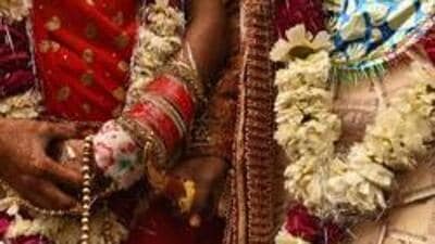 New Delhi, India - March 8, 2019: A groom and bride stand after performing rituals during a mass wedding for eight couples at Hanuman Vatika Ramleela Maidan, in New Delhi, India, on Friday, March 8, 2019. The purpose of organising mass weddings by social organisations is to help underprivileged economically backward families who cannot afford the high ceremony costs. (Photo by Burhaan Kinu / Hindustan Times) (Burhaan Kinu/HT PHOTO) New Delhi, India - March 8, 2019: A groom and bride stand after performing rituals during a mass wedding for eight couples at Hanuman Vatika Ramleela Maidan, in New Delhi, India, on Friday, March 8, 2019. The purpose of organising mass weddings by social organisations is to help underprivileged economically backward families who cannot afford the high ceremony costs. (Photo by Burhaan Kinu / Hindustan Times) (Burhaan Kinu/HT PHOTO)