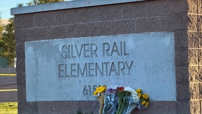 Flowers are placed beside a sign at Silver Rail Elementary School in Bend, Oregon on Friday, Oct. 16.