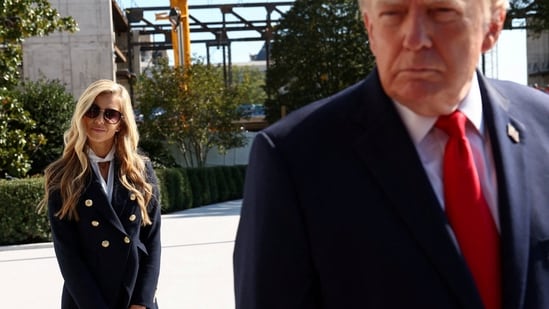 New White House Press Secretary Katie Zacharia stands behind US President Donald Trump as he departs the White House in Washington DC, October 13.