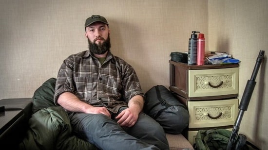 Stupnikov at his temporary apartment in Ukraine, where two sacks contain all his possessions and an anti-drone gun rests against the wall