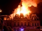 This photograph shows a fire burning and destroying the city hall after a group of individuals forced entry into the building during ongoing protest action against the "high cost of living", in Limoges, central France.