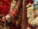 New Delhi, India - March 8, 2019: A groom and bride stand after performing rituals during a mass wedding for eight couples at Hanuman Vatika Ramleela Maidan, in New Delhi, India, on Friday, March 8, 2019. The purpose of organising mass weddings by social organisations is to help underprivileged economically backward families who cannot afford the high ceremony costs. (Photo by Burhaan Kinu / Hindustan Times) (Burhaan Kinu/HT PHOTO)