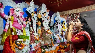 Dehradun: A woman offers prayers at a 'Pandal' during the Durga Puja festival, in Dehradun, Saturday, Oct. 17, 2026. (PTI Photo)(PTI10_17_2026_000211B) (PTI) Dehradun: A woman offers prayers at a 'Pandal' during the Durga Puja festival, in Dehradun, Saturday, Oct. 17, 2026. (PTI Photo)(PTI10_17_2026_000211B) (PTI)