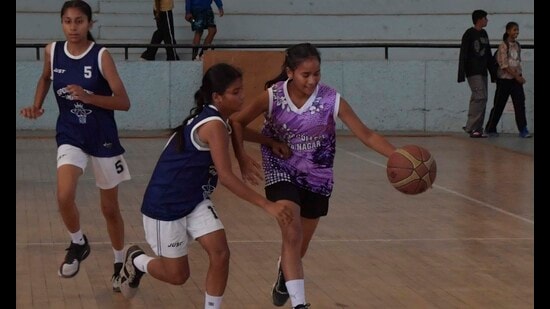 Players in action during a basketball match at Guru Nanak Stadium in Ludhiana on Saturday. (Manish/HT)
