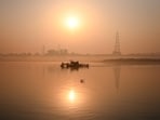 Gram it: The Yamuna catches the first light of the day as a cleaning drive by some volunteers were underway at ITO Yamuna Ghat in New Delhi on Sunday. The golden reflections on the water offer a moment of calm, even as efforts to clean the river continue.