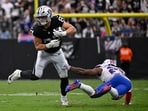 Las Vegas Raiders tight end Michael Mayer makes a catch in front of Buffalo Bills safety C.J. Gardner-Johnson.