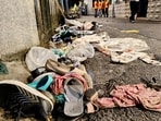 Footwear and other items lie scattered at the site after the stampede at Chorebagan Sarbojanin Durga Puja pandal, in Kolkata on Saturday.
