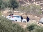 Vehicles at the site where Belgium's foreign minister says masked settlers in the Israeli-occupied West Bank attacked Palestinians, Catholic representatives and Western diplomats and officials, in Taybeh, in the Israeli-occupied West Bank, October 17, 2026. in this screengrab from a video.
