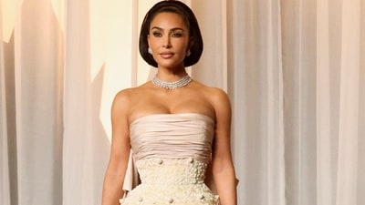Kim Kardashian channels Elizabeth Taylor at the 2026 Academy Museum Gala in an archival 1951 Balenciaga gown featuring delicate lace details, a pink sash, and a dramatic bow. (REUTERS)