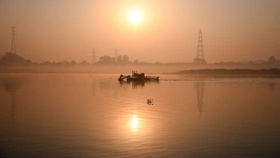 Gram it: The Yamuna catches the first light of the day as a cleaning drive by some volunteers were underway at ITO Yamuna Ghat in New Delhi on Sunday. The golden reflections on the water offer a moment of calm, even as efforts to clean the river continue. (Photo: Neeraj Kohli/ANI)