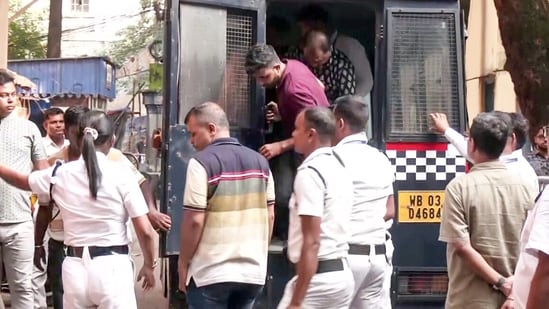 Seven people arrested in connection with the Chorbagan Sarbojanin Durga Puja stampede incident are being brought to Bankshall Court, in Kolkata on Sunday. (ANI Video Grab)