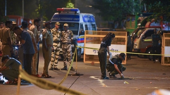 A forensic team collects samples from the spot where shots were fired at actor Tiger Shroff, in Mumbai on Sunday. Actor is safe and has not sustained any gunshot injuries.